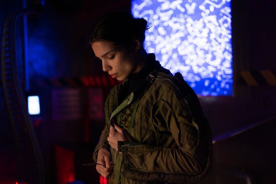 from sci fi salary rise - A woman in a sci-fi environment wearing a futuristic jacket, surrounded by technology and lights.