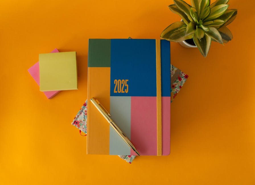 top add ons your 2025 - A vibrant flat lay of a 2025 planner, pen, sticky notes, and plant on a bright background.